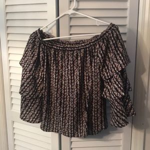 Cold shoulder blouse with flowing sleeves.